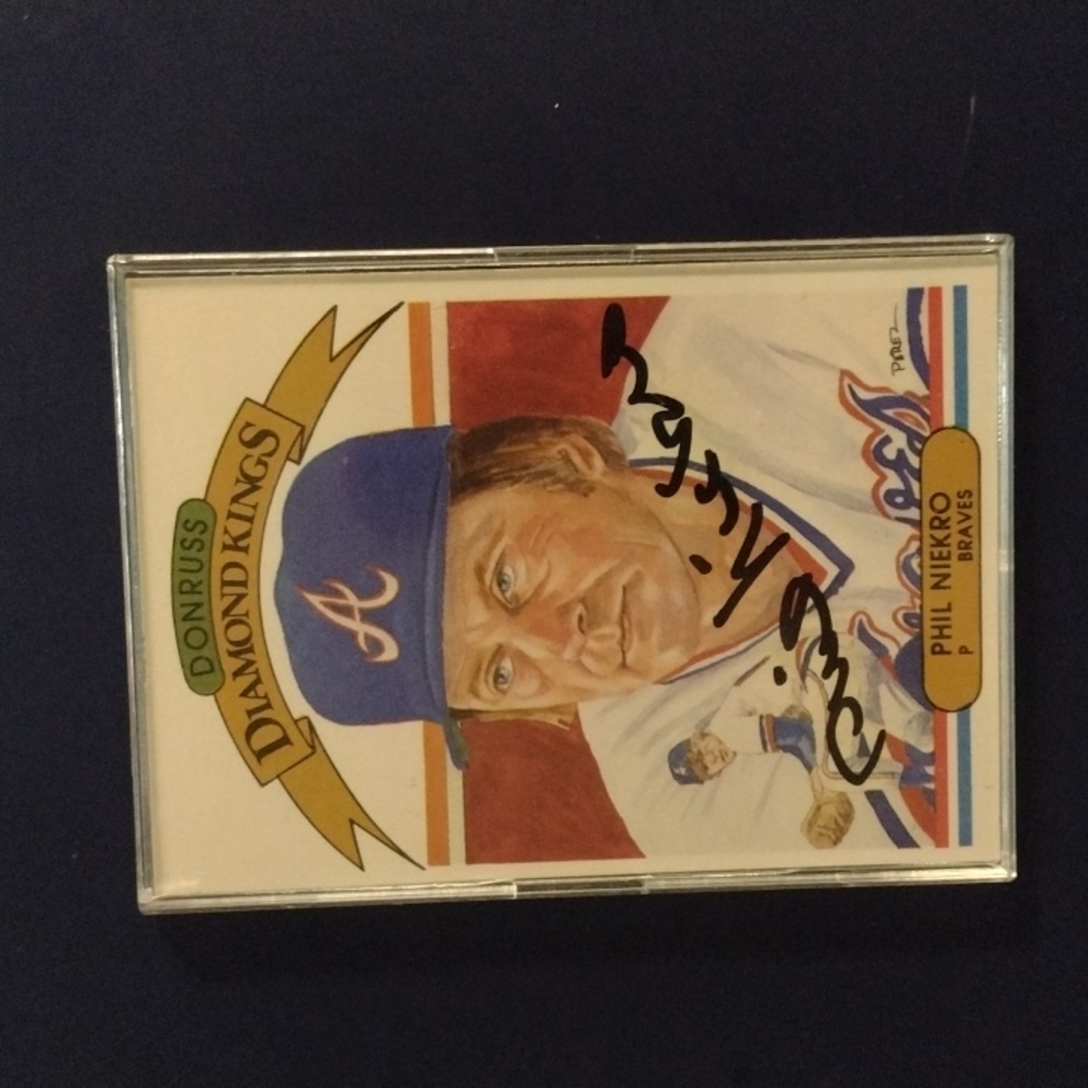 Phil Niekro autographed baseball card in protective cover